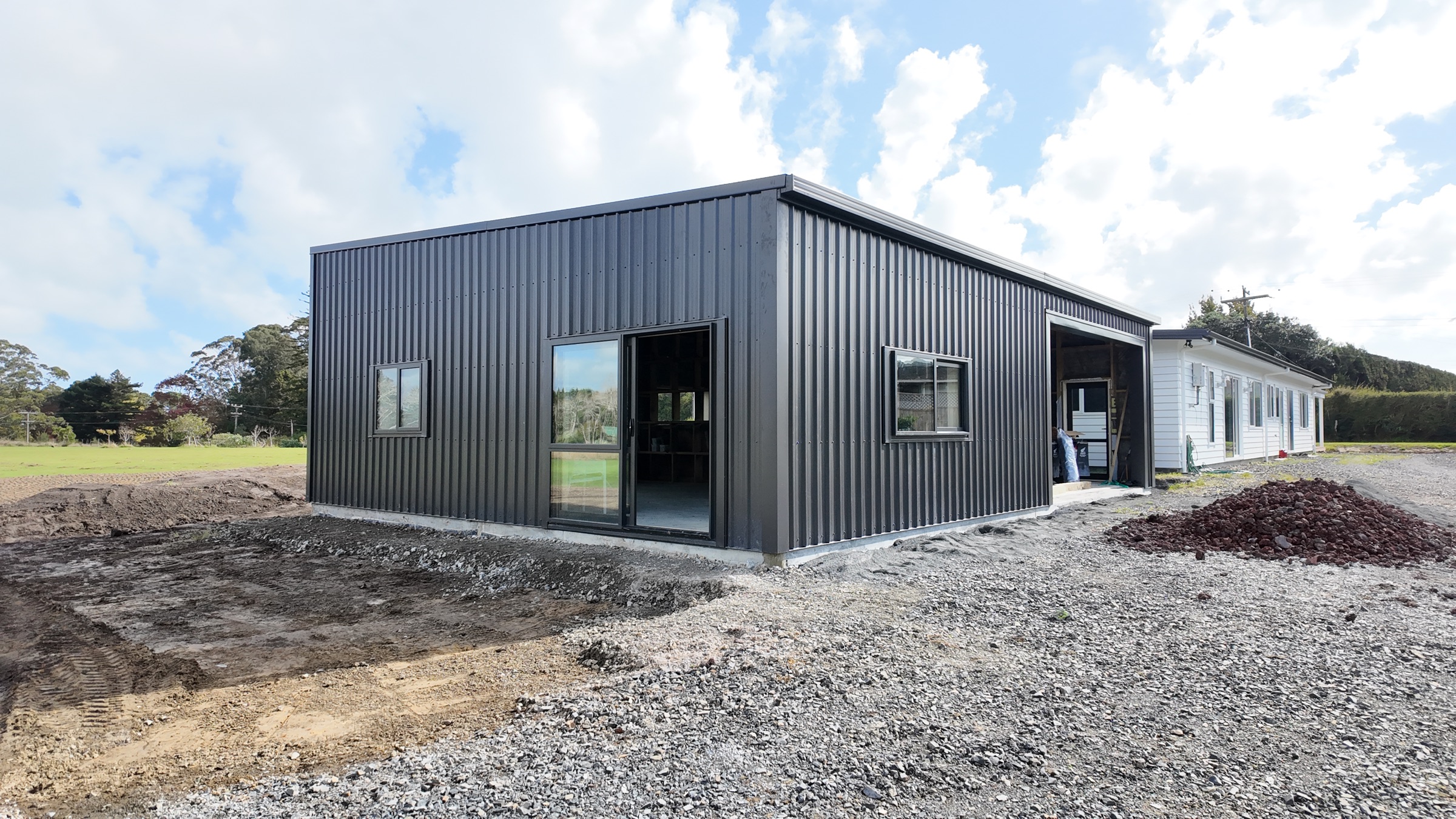 Completed dark metal-clad garage in Whenuapai