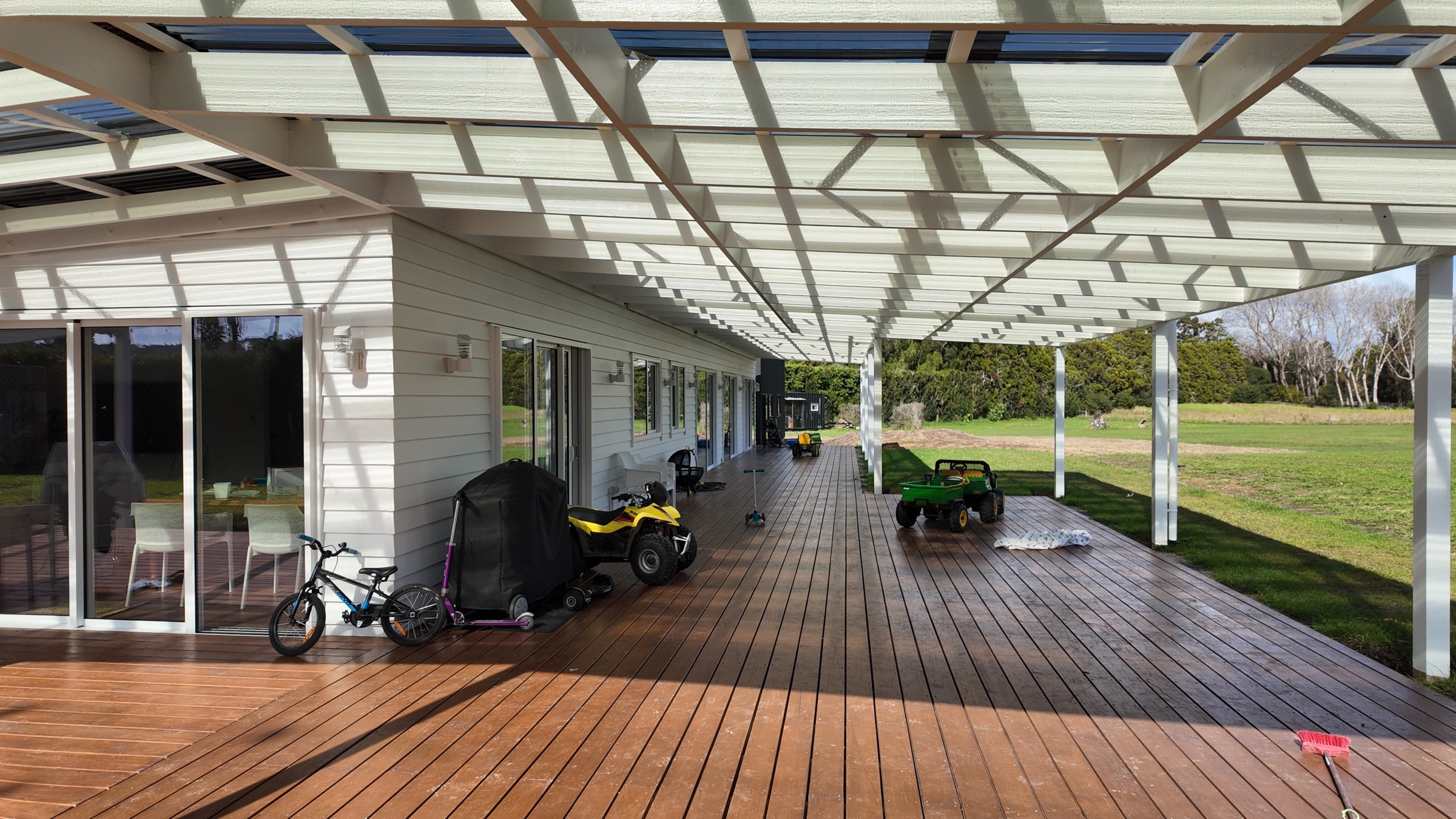 Finished timber deck beneath the translucent pergola roof