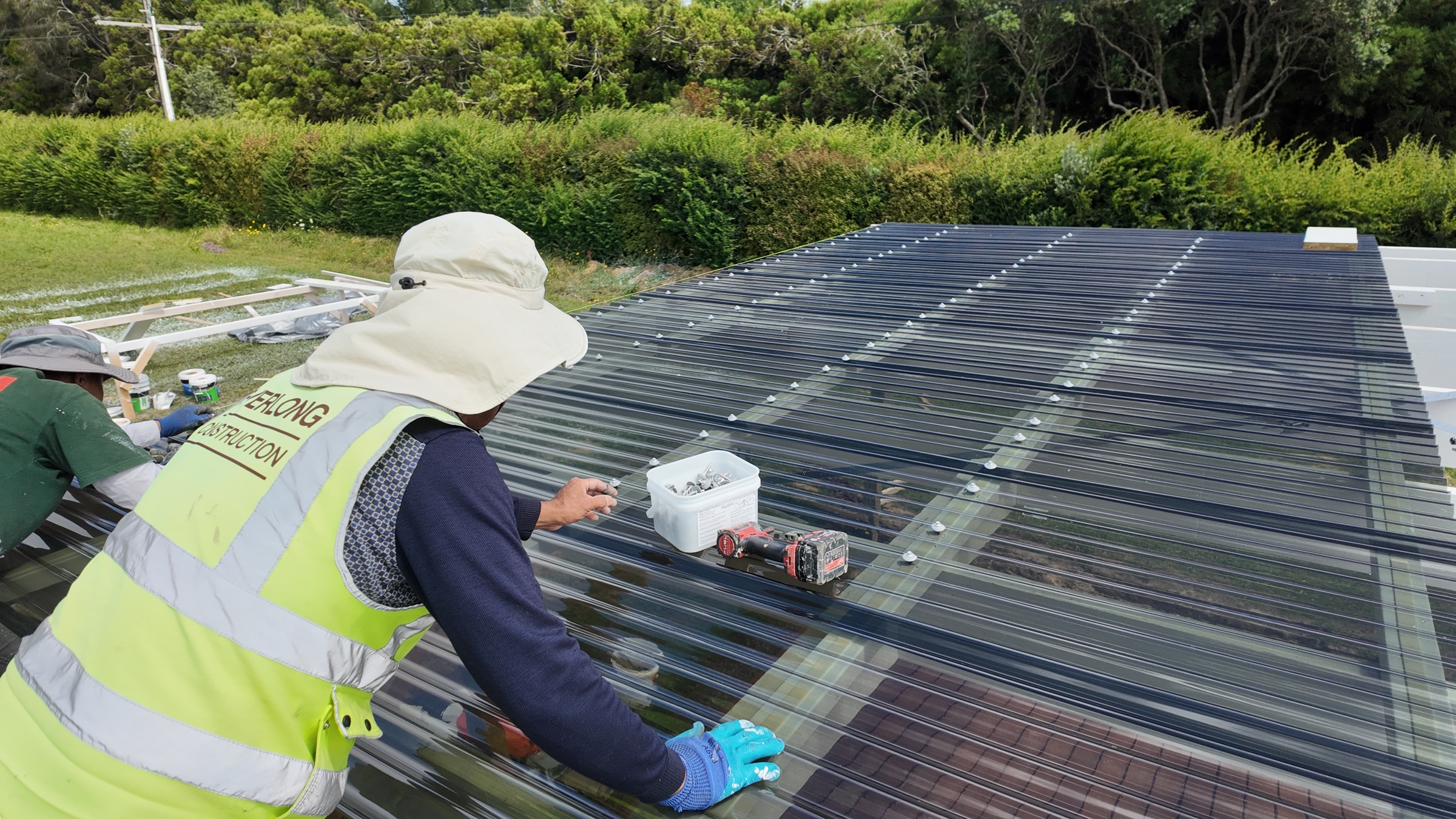 Translucent pergola roofing being installed