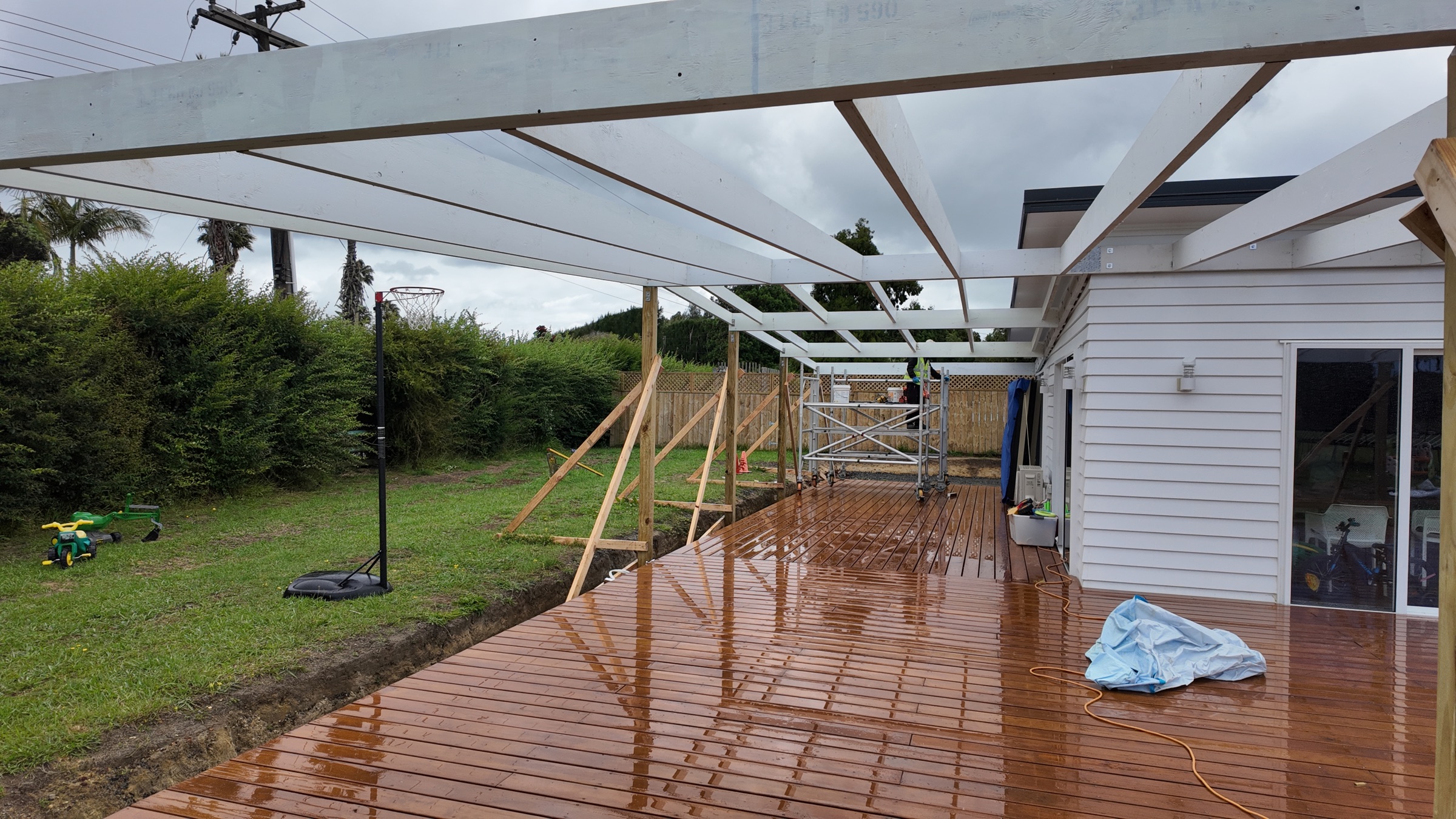 Veranda beams and posts installed around the existing deck
