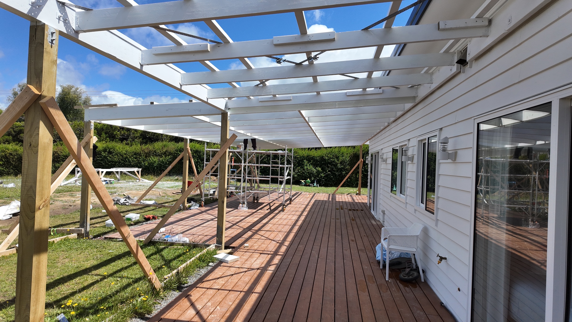 Painted white veranda roof framing above the deck