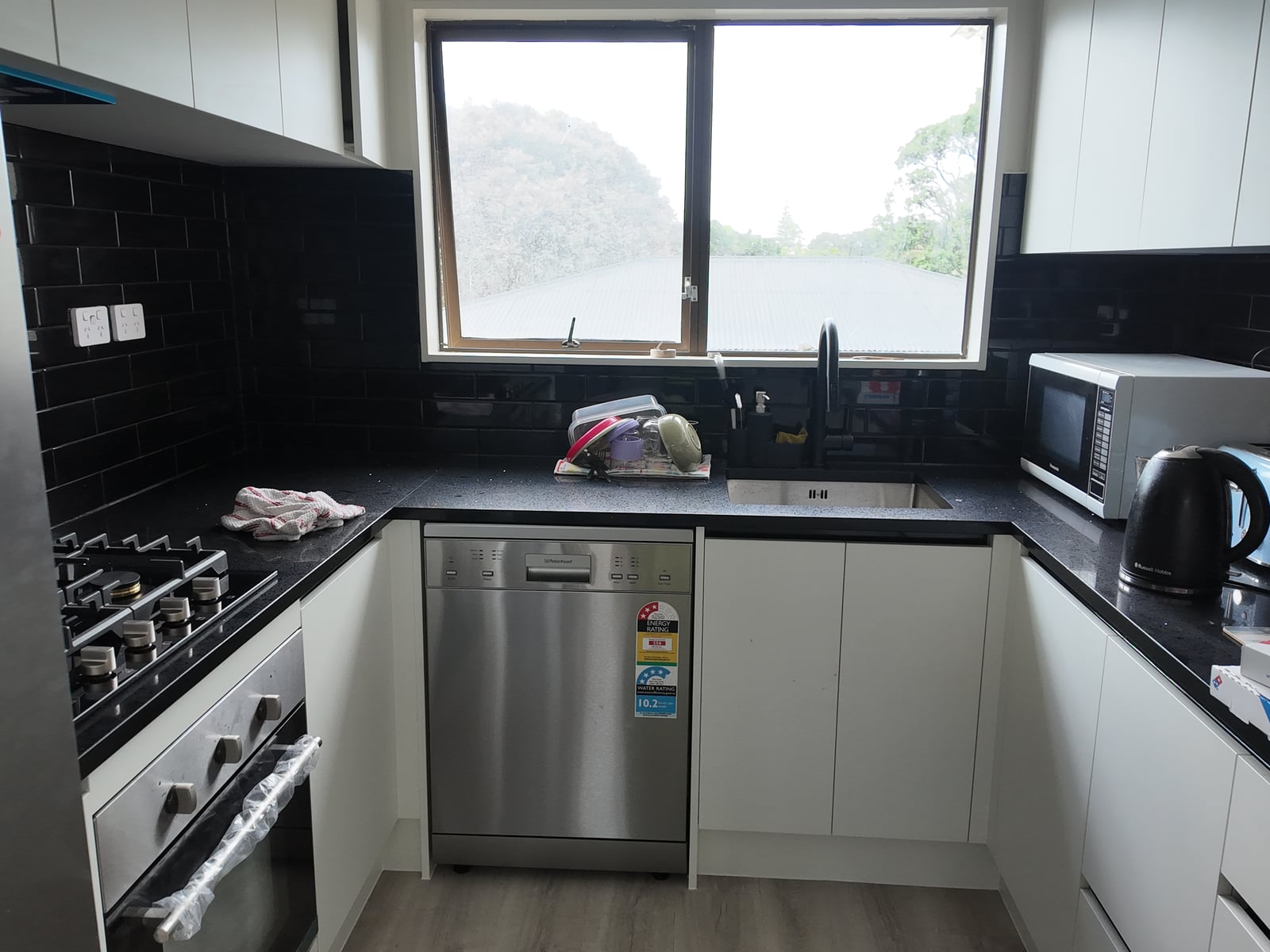 Kitchen appliance wall with stainless refrigerator and oven