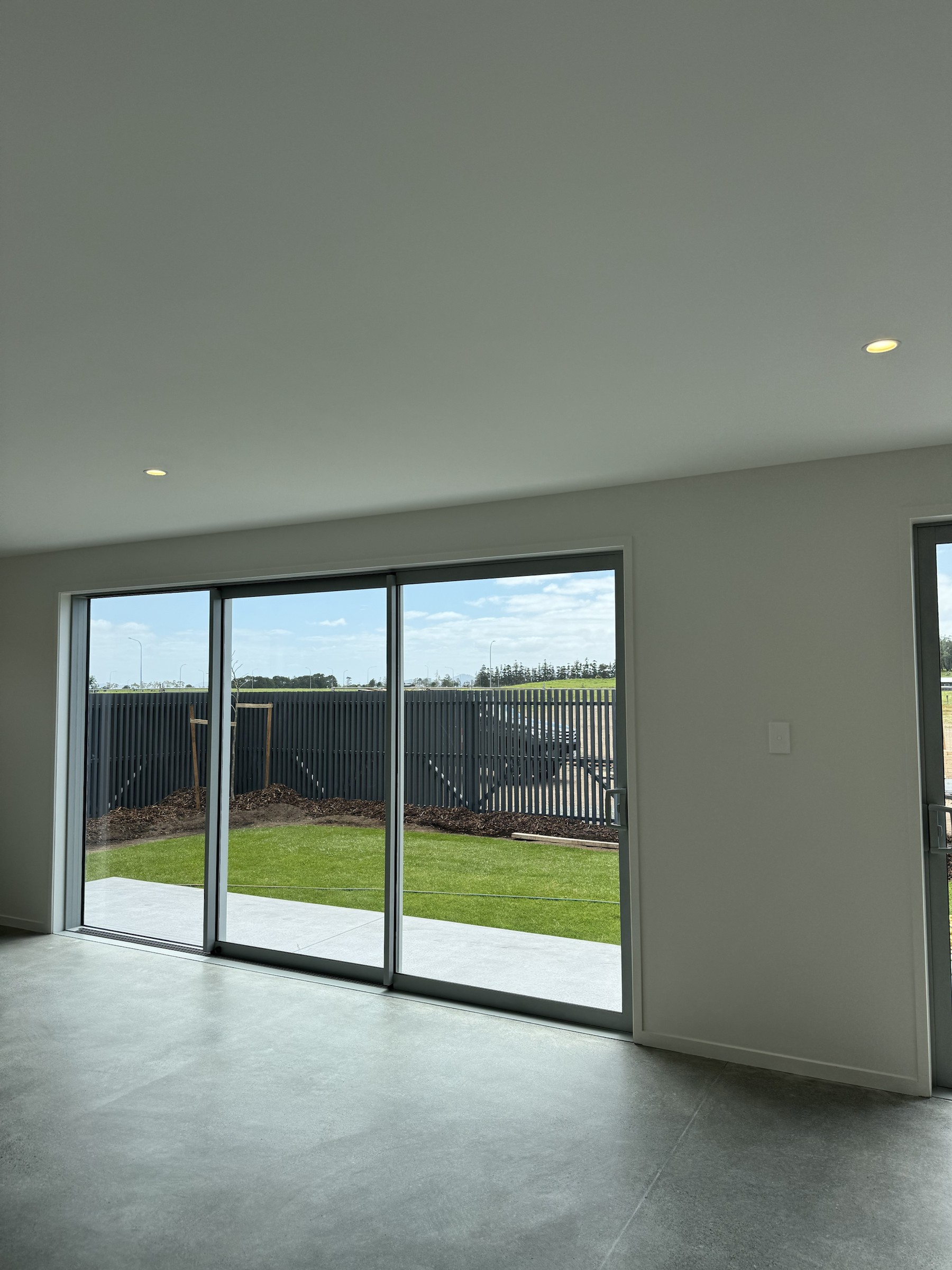 Living area opening through large glazed sliders to the lawn