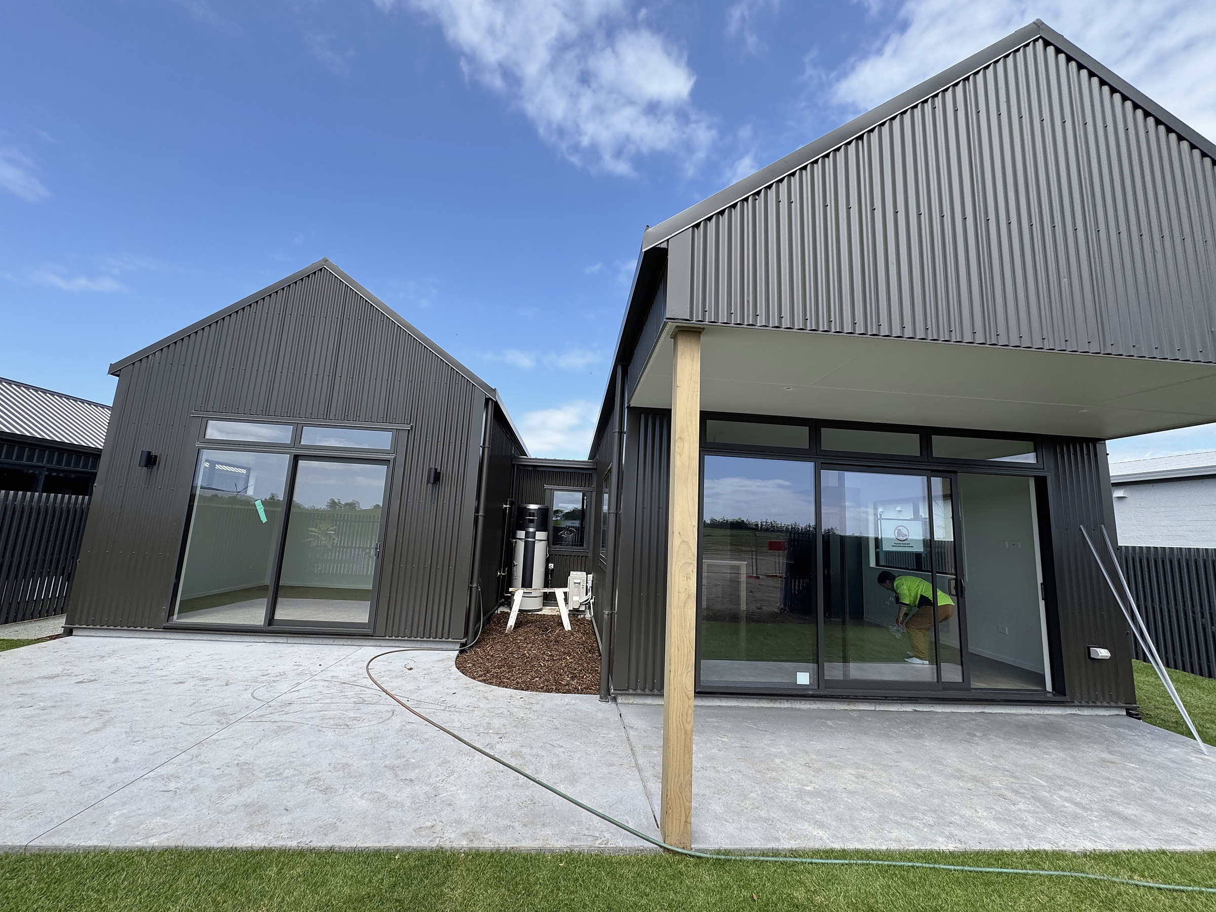 Covered patio and dark-clad exterior of House 44