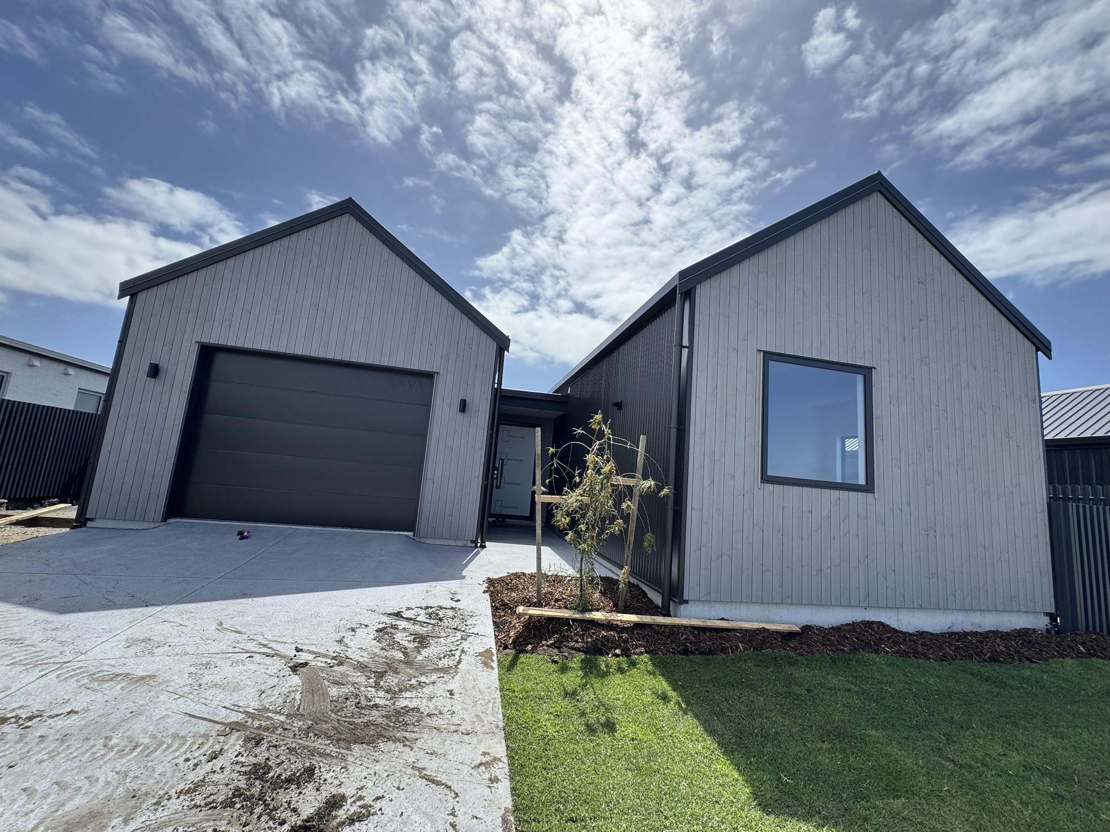 Street elevation with garage and vertical timber cladding