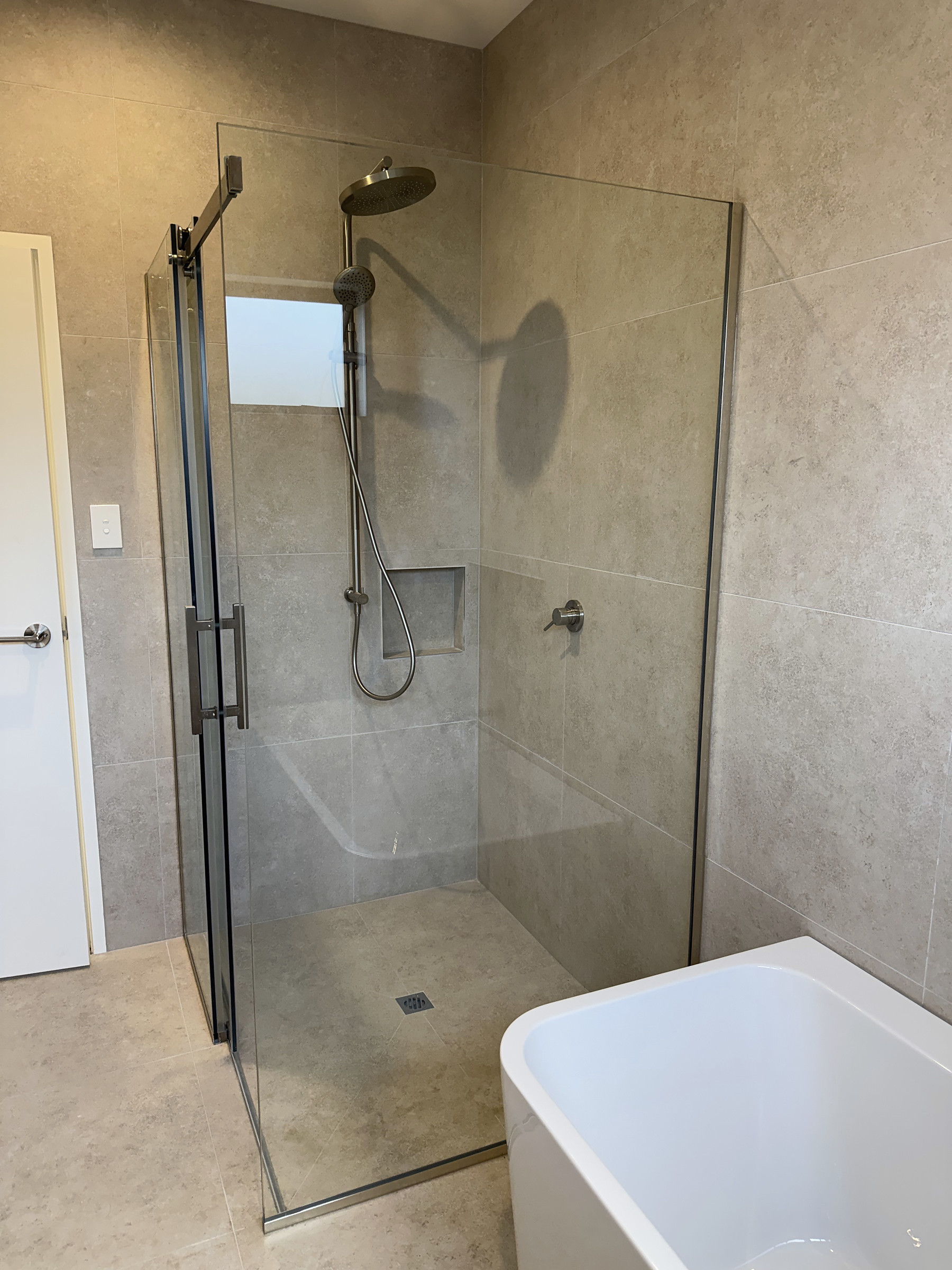 Tiled shower beside the bath in House 44